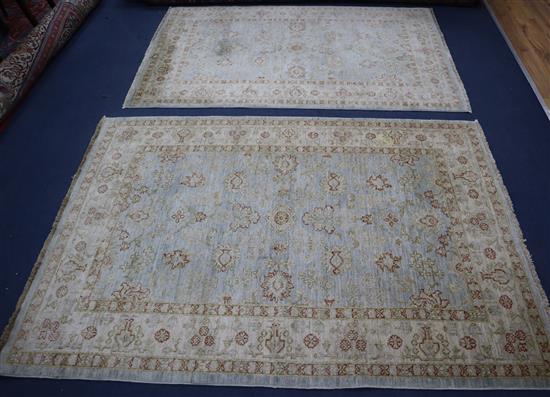 Two blue and cream Pakistan rugs 195 x 128cm and 200 x 143cm